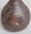 A signed Japanese studio pottery bud vase in the Bizen tradition, hand thrown from iron-rich stoneware with an unglazed...
