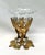 This vintage brass cherub pedestal bowl pairs a detailed gilt-toned figural base with a faceted glass insert for a classic...