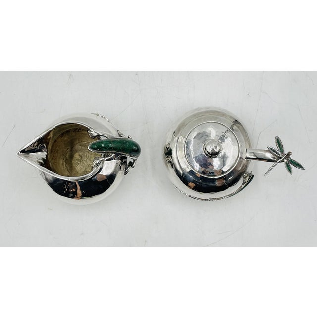 An exceptional Mid-Century Modern silver-plated creamer and covered sugar bowl designed by Emilia Castillo for the...