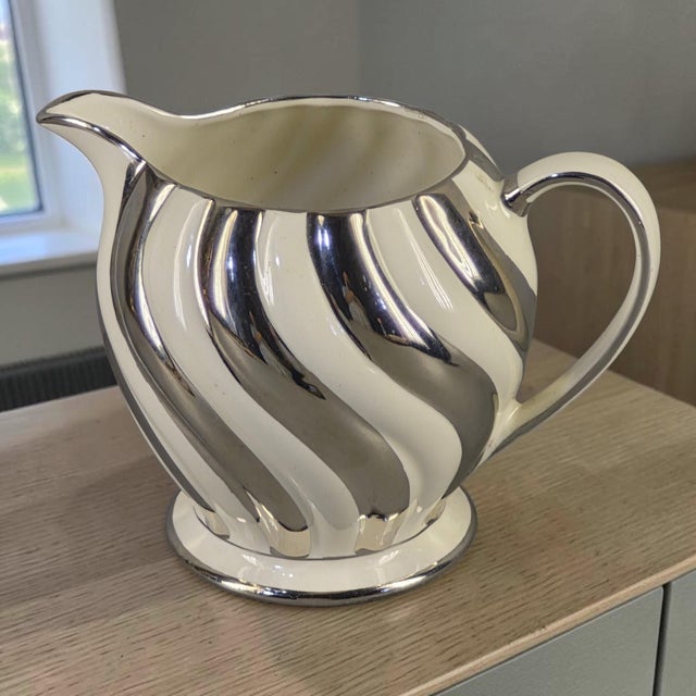 This Elegant Vintage Sadler England Silver & Cream Swirl Porcelain Milk Pitcher is a classic and graceful addition to any...