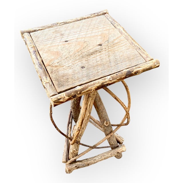 This antique Adirondack table showcases the artistry of folk craftsmanship. Its twig frame supports a weathered gray...
