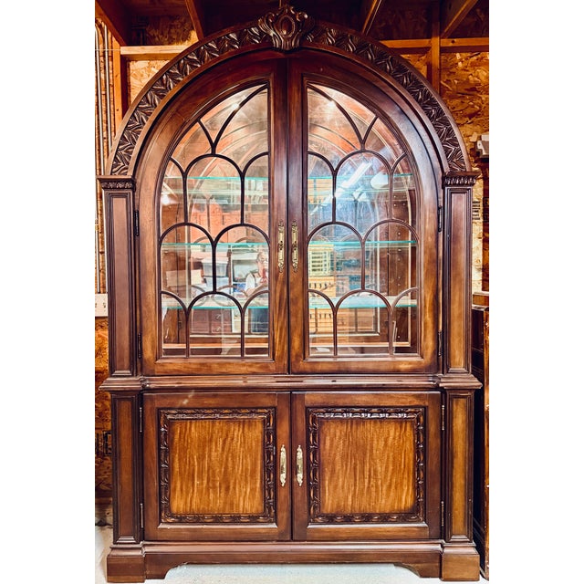 Traditional high end formal china cabinet with Neoclassical and Gothic revival influences. with its cathedral style arch...