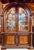 Traditional high end formal china cabinet with Neoclassical and Gothic revival influences. with its cathedral style arch...