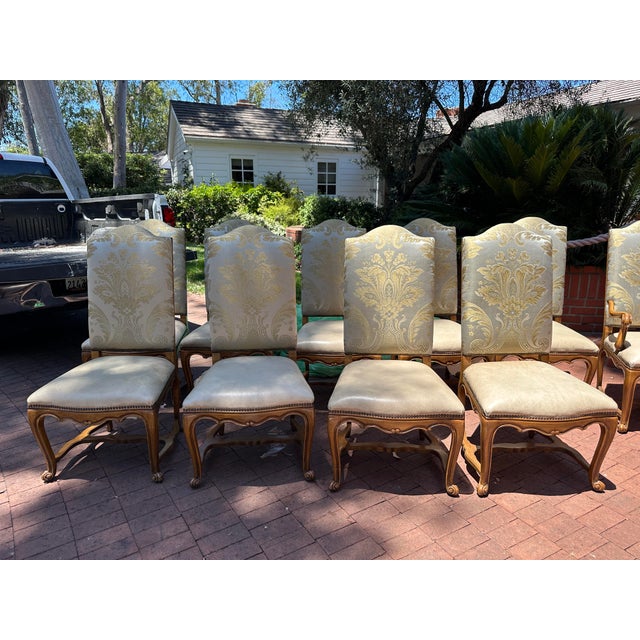 A distinguished set of twelve authentic William Switzer dining chairs, including ten side chairs and two coordinating host...