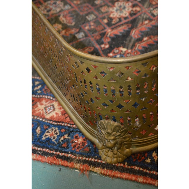 Great old brass fireplace fender. Simple design, but classy with the lions!