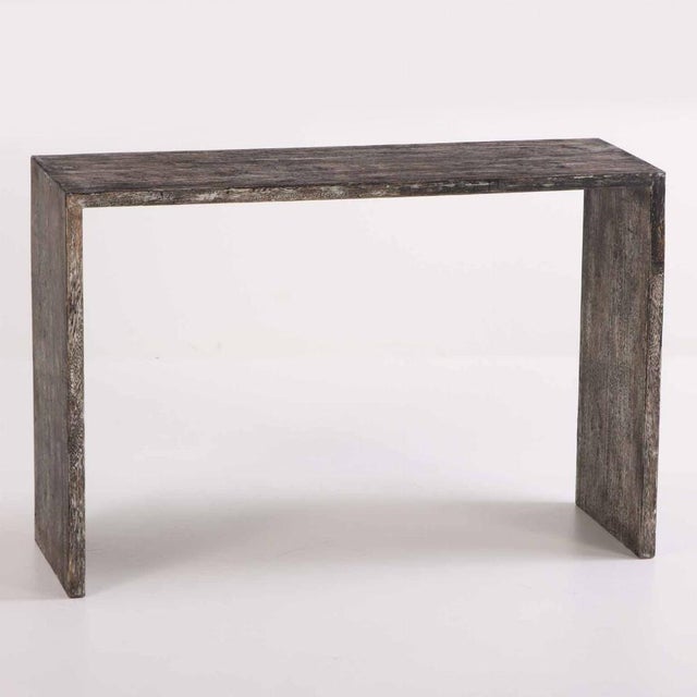 This beautiful waterfall table has an inverted U-form which will add simple and understated elegance to your décor. A...