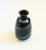 A small vintage ceramic bud vase. Dark glazes with a spiral design wrapping around the sides. Nice tapered shape. Original...