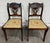 This is a pair of vintage Duncan Phyfe Regency style mahogany dining chairs featuring pierced Chippendale-style splat...