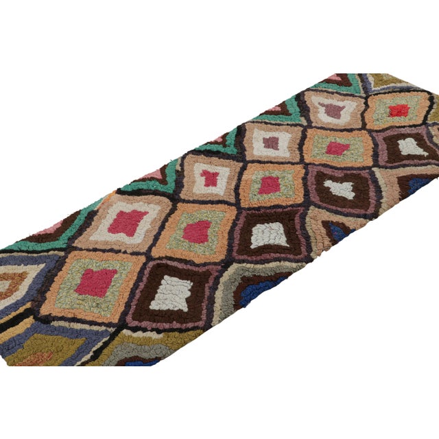 Hand-knotted in wool, circa 1950-1960, this 2x6 vintage Moroccan runner rug is believed to hail from the Azilal tribe. On...