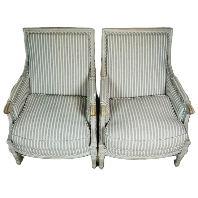 A pair of early 20th century bergeres in the style of Louis XVI. These chairs are high quality shop made examples of the...