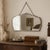 A c. 1930s–1940s Art Deco wall mirror with beveled glass, hanging chain, and a small silver-toned crest. Its foxing, edge...