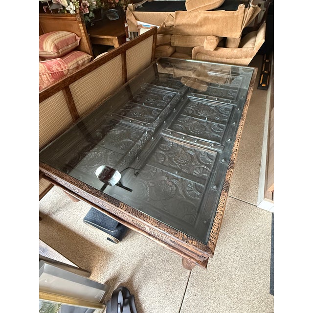 Custom made oversized coffee table made from beautiful and intricately carved Indian Doors. Finish was restored in 2009...