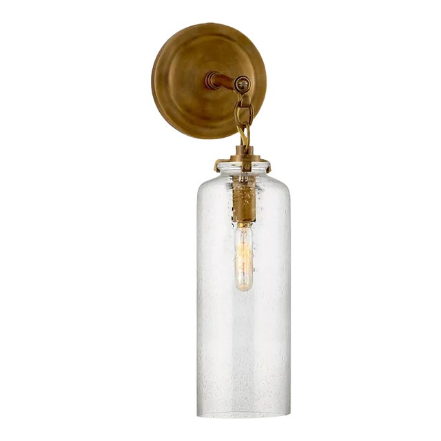 Thomas O'Brien for Visual Comfort Signature Katie Small Cylinder Sconce in Hand-Rubbed Antique Brass with Seeded Glass For Sale