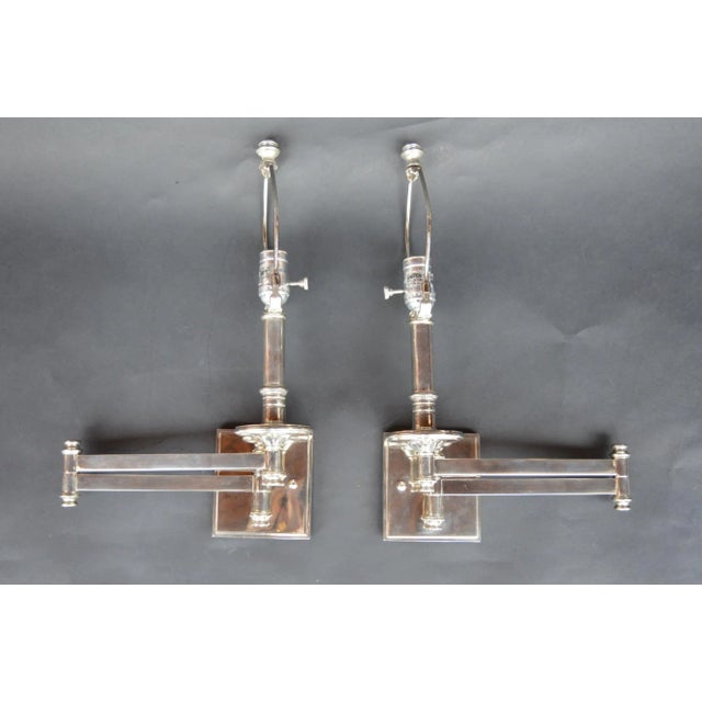 Pair of chrome sconces with articulating arms. Measurements are with the arm fully extended.