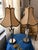 Beautiful pair of decorative table lamps featuring elegant faceted mirrored-glass bases with dark or metal trim and warm...