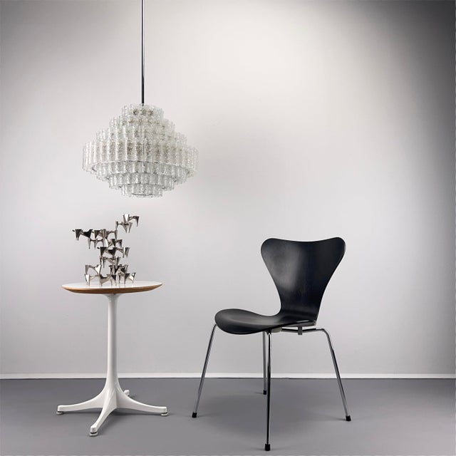 167 frosted glass tubes are suspended in staggered rings within the metal frame. A very impressive 1970s chandelier with...