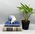 A charming Delft-style ceramic piggy bank featuring cobalt blue flowers and foliage against a creamy white ground. Made in...