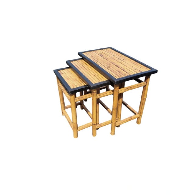 A wonderful set of 3 real bamboo nesting tables. The tables are made of real bamboo in a deep dark honey color with black...