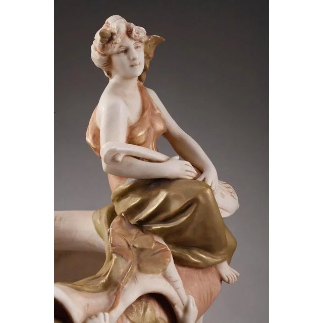 Large royal dux cup crafted in porcelain biscuit. The biscuit is partially enameled, and highlighted with polychrome...