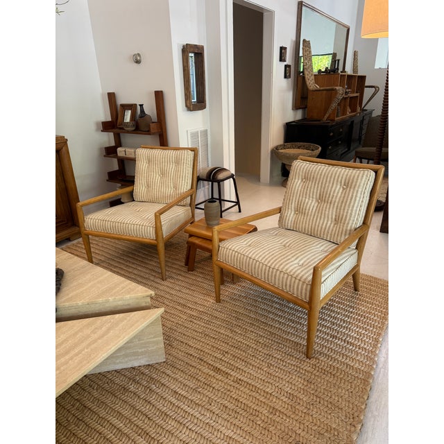 Pair of 1950s T.H. Robsjohn Gibbings armchairs, newly reupholstered in a striped linen fabric. These lounge chairs feature...
