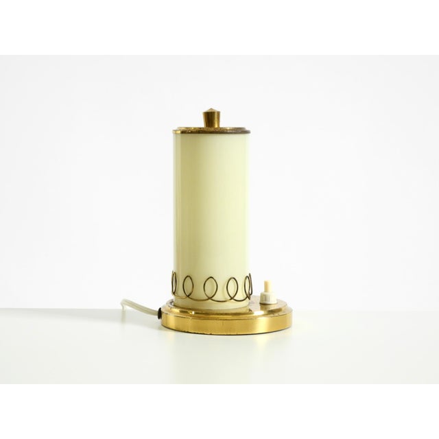 Very rare brass table lamp with a beige opal glass shade, dating from the 1950s. Stunning Mid-Century design in original...