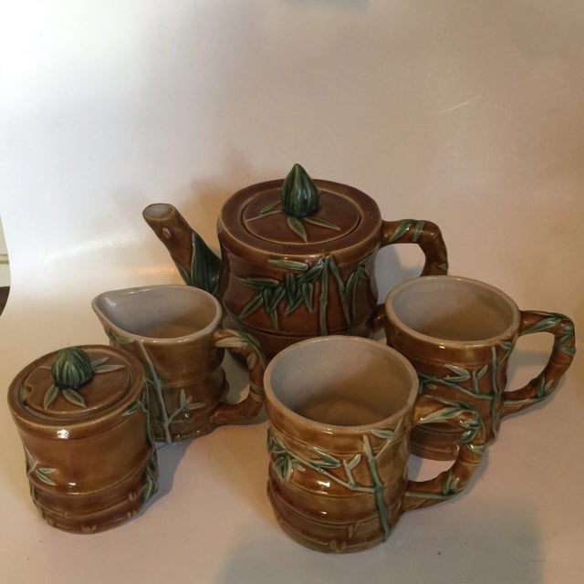 Beautiful collection of ceramic bamboo coffee set and teapot. Set includes five pieces with original tops. Cups measure 4"...