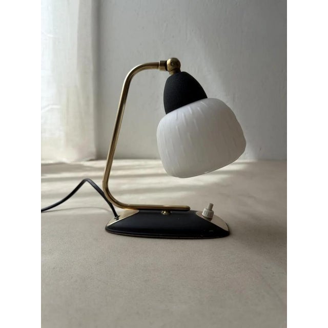 with smaller objects, design often matters most. This is certainly true for this table lamp from the 1950s. The base...
