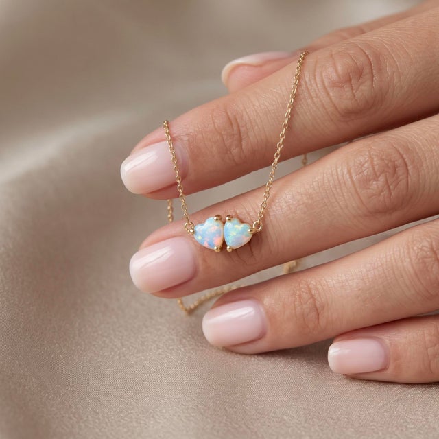Illuminate your collection with this dreamy two-stone pendant necklace, featuring two iridescent white heart-shaped...