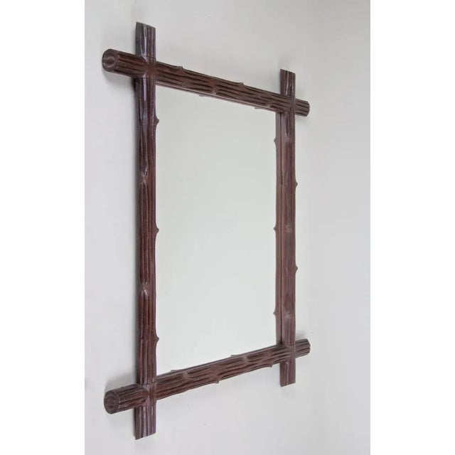 From circa 1900, the turn of the century in Austria comes this lovely wooden black forest wall mirror. A simple but...