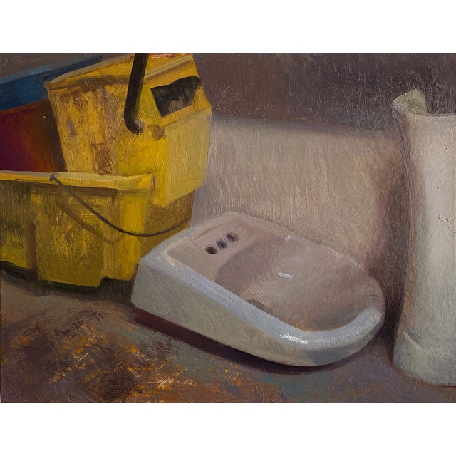 Mop Room by Brad Davis | Oil Painting of a yellow mop bucket and a white sink For Sale