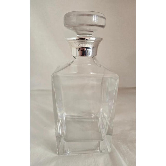 A refined British cut-glass spirit decanter by James Dixon & Sons, dating to 2001 and distinguished by a hallmarked...