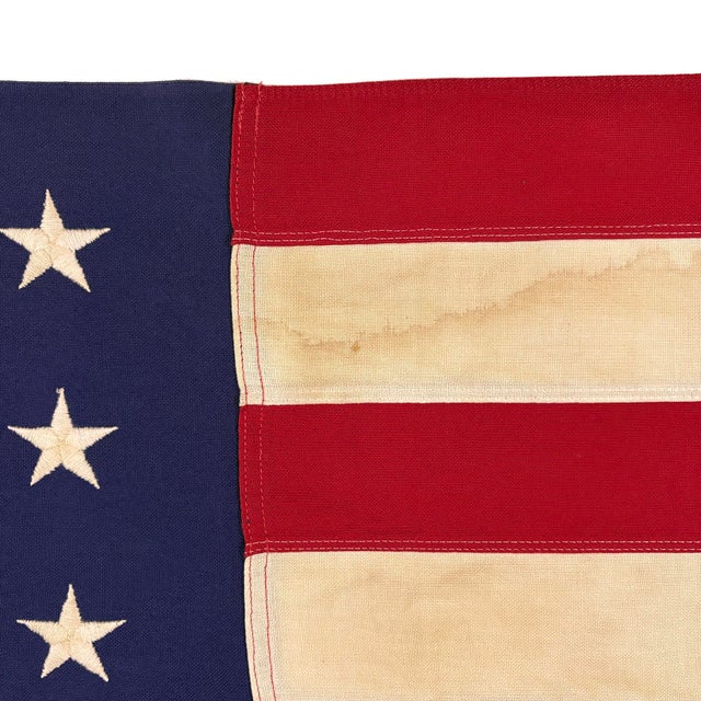 This vintage American flag is made from a cotton cloth with fully sewn stripes and 50 embroidered stars. Please note...