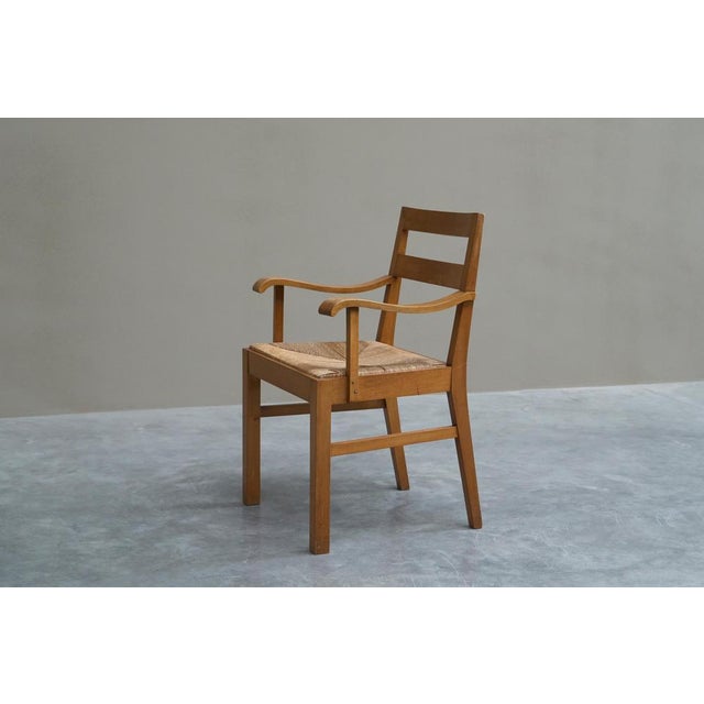 Unique Oscar Degeyter armchair in solid wood and rush. Belgium, 1942. Created during WWII, this unique Oscar De Degeyter...
