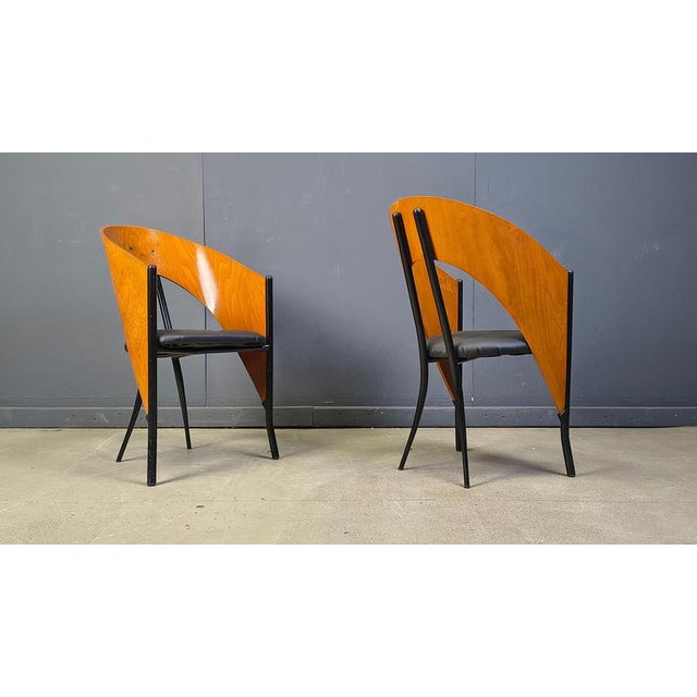 Gorgeous dining chairs with elegant metal and wooden frames and a black faux leather seat. The chairs are designed much in...