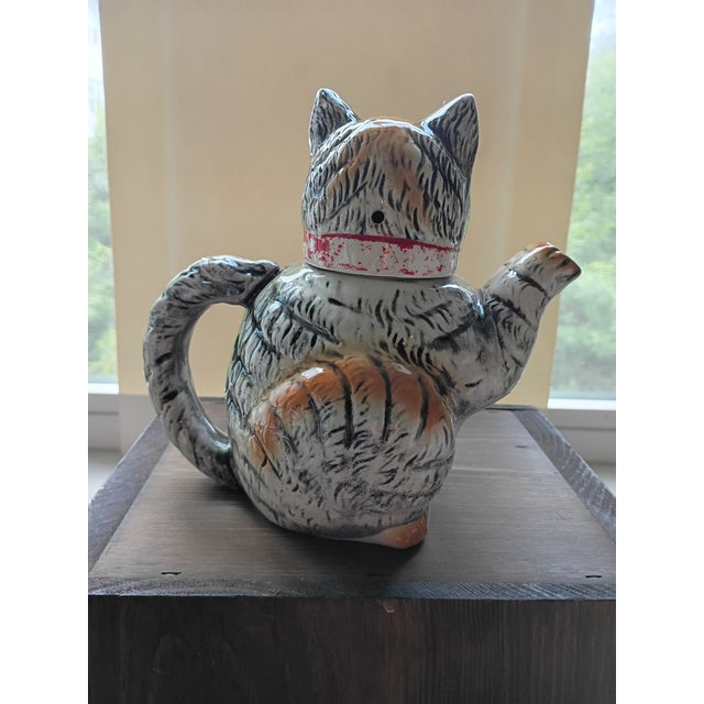 Bring whimsical mid-century charm to your kitchen counter or display shelf with this vintage Japanese figural cat teapot....