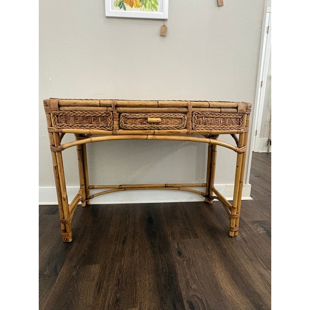 Beautiful, vintage wicker and bamboo writing desk with a matching chair featuring woven rattan details and a single...