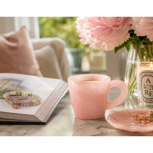 A beautifully hand-carved cup crafted from 100% natural rose quartz, prized for its soft blush-pink color, gentle...