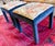 Charming pair of matching foot stools or ottomans upholstered in an orange print on the top and black velvet legs. Fabric...