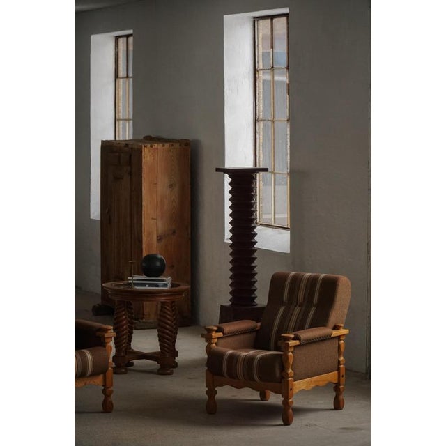 A fascinating sculptural pair of Danish modern lounge chairs in the manner of Henning (Henry) Kjærnulf. Made in solid oak...