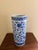 A classic blue and white porcelain umbrella stand in the chinoiserie tradition, featuring Asian floral designs. The crisp...