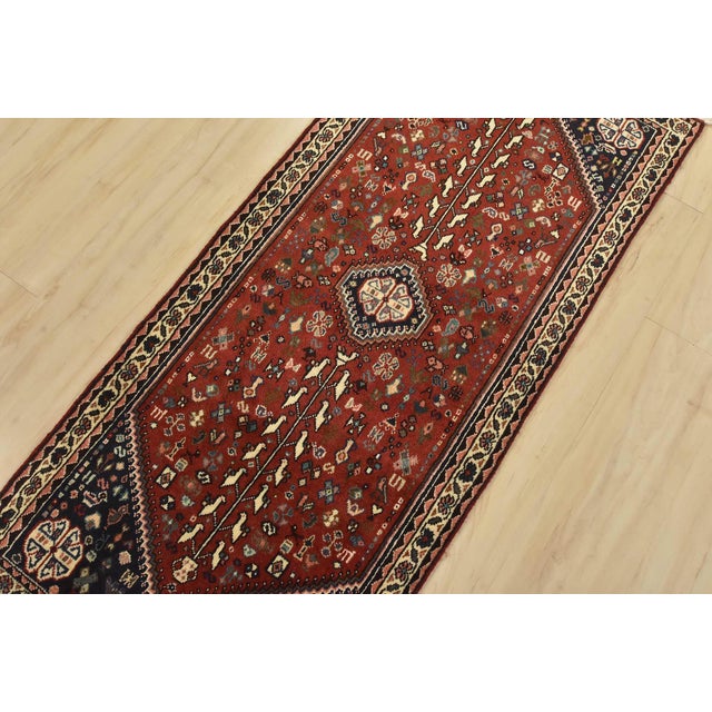 An authentic vintage tribal Abadeh runner hand-knotted with fine wool and natural dyes. This intricately woven rug...