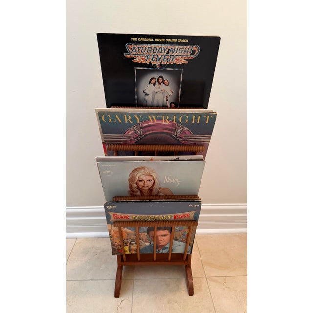 A distinctive vintage Scandinavian Modern magazine rack dating to approximately the late 1960s, thoughtfully repurposed as...