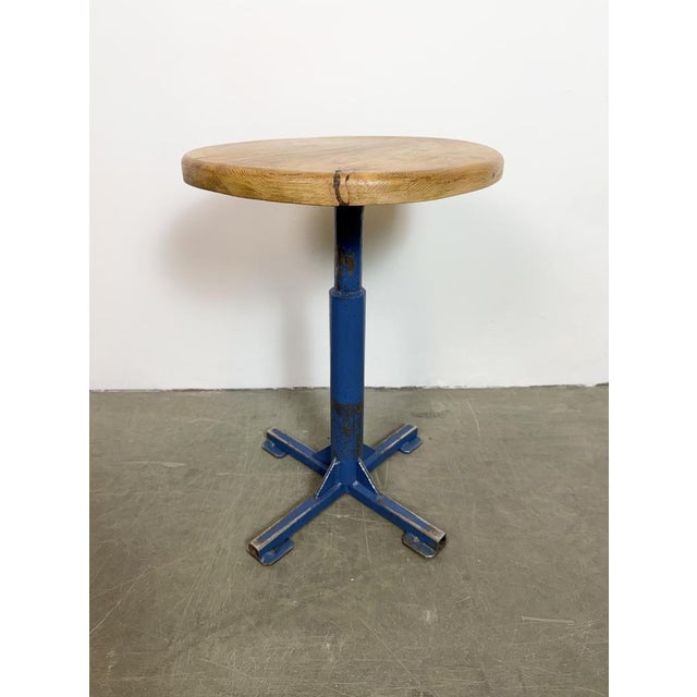 Vintage industrial stool. It features a blue iron leg and a solid wooden seat. The diameter of the seat is 35 cm. The...