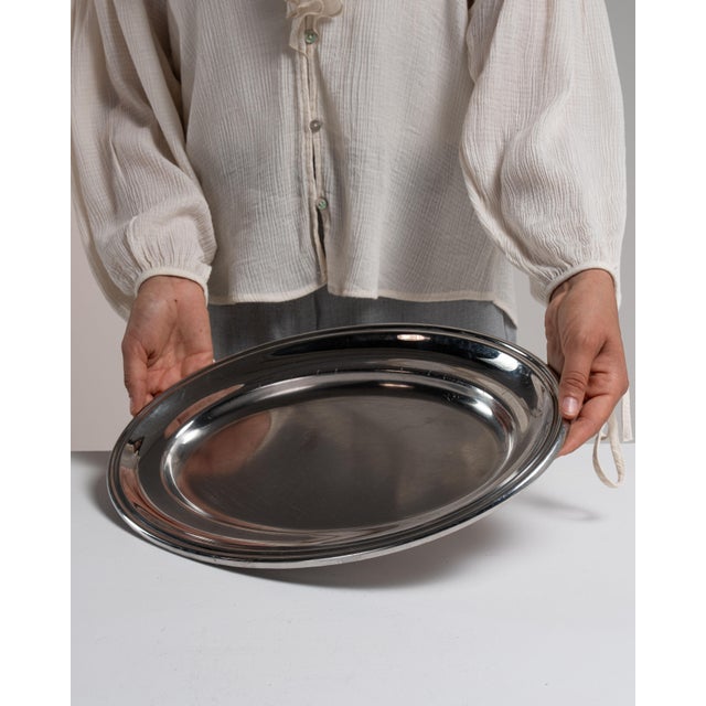 This early 20th century tray from France is finished in gray, worked in silver. Its form follows honest, well-proportioned...