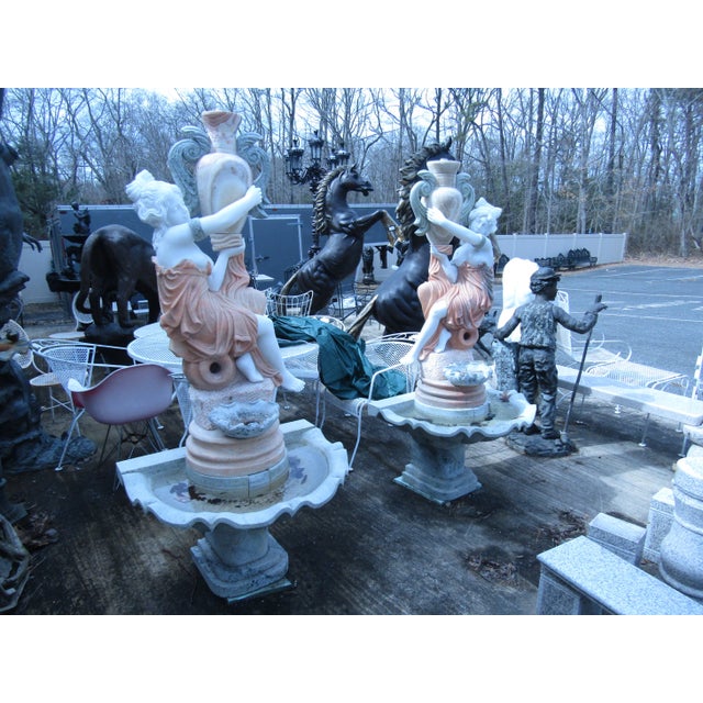 Beautiful marble fountain or birdbath of a cloaked figure pouring water. WEAR Some broken pieces in the marble. DIMENSIONS...