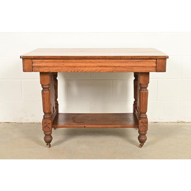 A gorgeous antique Victorian carved oak library table or writing desk In the manner of Herter Brothers USA, Circa Late...
