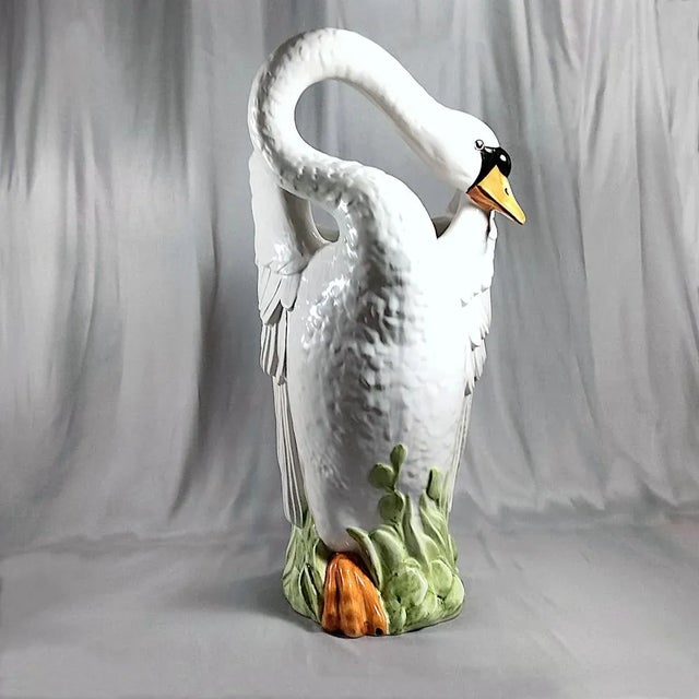 A large, vintage, hand-painted Italian ceramic swan standing in marsh grass with an open interior for both indoor and...