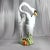 A large, vintage, hand-painted Italian ceramic swan standing in marsh grass with an open interior for both indoor and...