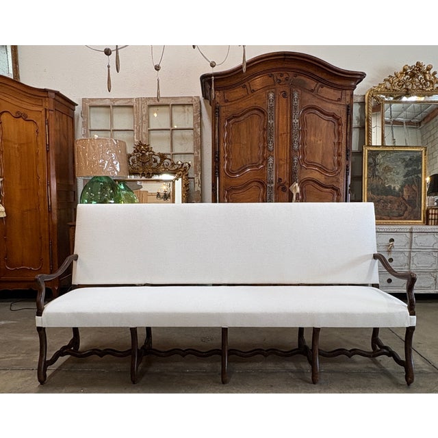 This beautiful long 20th Century French Os de Mouton walnut, Mutton leg, sofa is a timeless piece of French provincial...