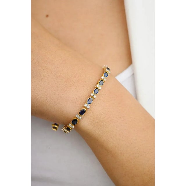 This is part of Chairish’s Fine Jewelry assortment. This 6.91 CTW Natural Blue Sapphire Diamond Wedding Tennis Bracelet in...